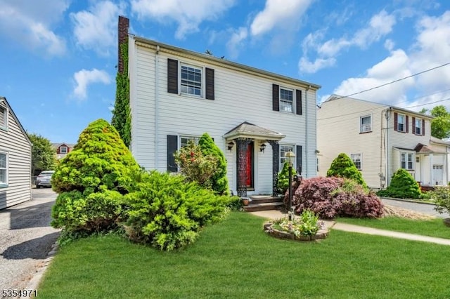 123 Robbinwood Ter, Linden City, NJ 07036 - view of front of house featuring a chimney and a front lawn