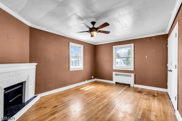 123 Robbinwood Ter, Linden City, NJ 07036 - unfurnished living room with radiator heating unit, light wood finished floors, a ceiling fan, baseboards, and crown molding