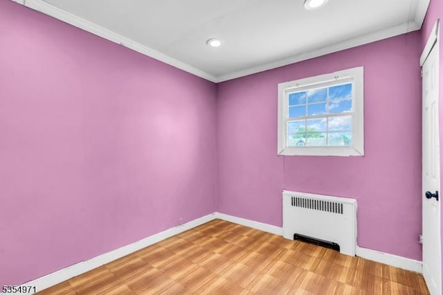 123 Robbinwood Ter, Linden City, NJ 07036 - unfurnished room featuring radiator, ornamental molding, baseboards, recessed lighting, and light wood-style floors