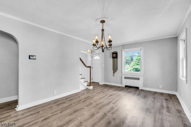 123 Robbinwood Ter, Linden City, NJ 07036 - unfurnished dining area with radiator heating unit, ornamental molding, stairway, wood finished floors, and arched walkways
