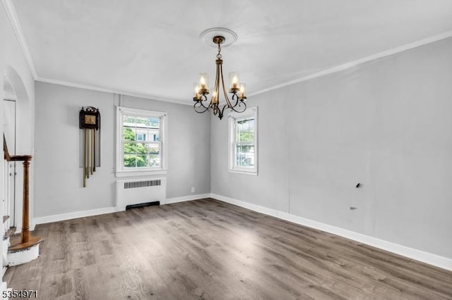 123 Robbinwood Ter, Linden City, NJ 07036 - unfurnished dining area featuring radiator, crown molding, a chandelier, wood finished floors, and arched walkways