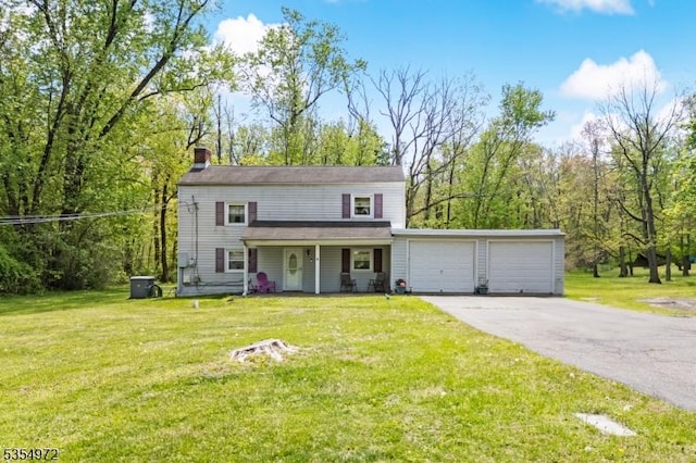 traditional-style home with an attached garage, a front lawn, a chimney, covered porch, and driveway