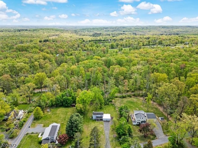 drone / aerial view featuring a view of trees