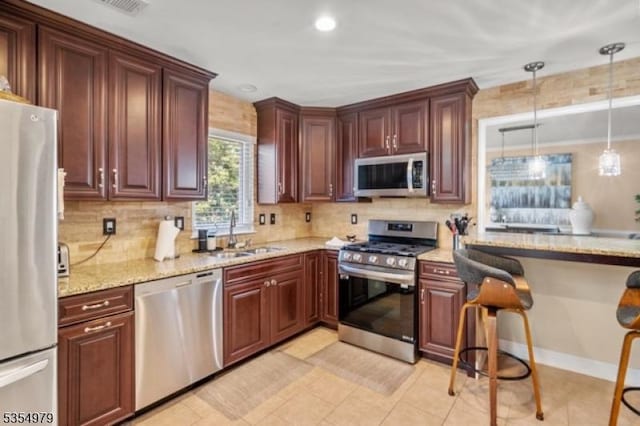 8 Congress Ln, South River Boro, NJ 08882 - kitchen featuring a sink, appliances with stainless steel finishes, backsplash, and light stone counters