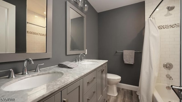 3 Grant St, Cranford Twp, NJ 07016 - bathroom featuring double vanity, toilet, shower / bath combo, baseboards, and wood finished floors