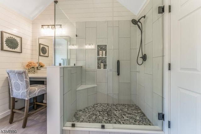 full bathroom featuring a shower stall and lofted ceiling