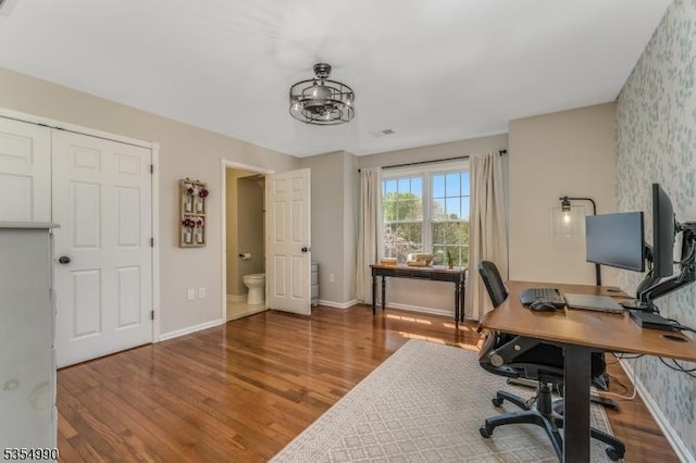 office space featuring wallpapered walls, wood finished floors, and baseboards