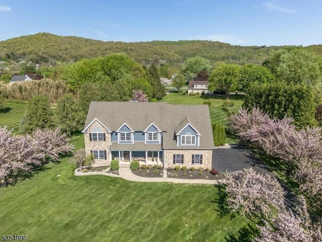 aerial view featuring a wooded view