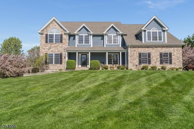 view of front facade featuring stone siding and a front yard