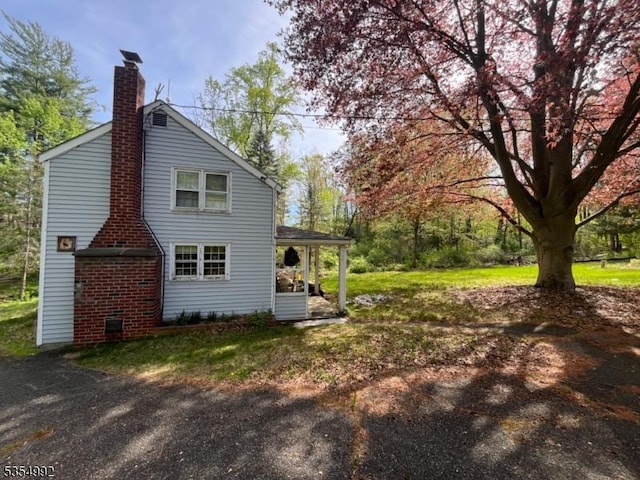 view of property exterior featuring a chimney