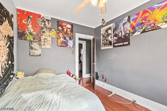 bedroom with crown molding, ceiling fan, and wood finished floors