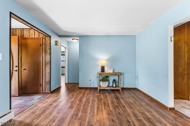 foyer entrance featuring wood finished floors and baseboards