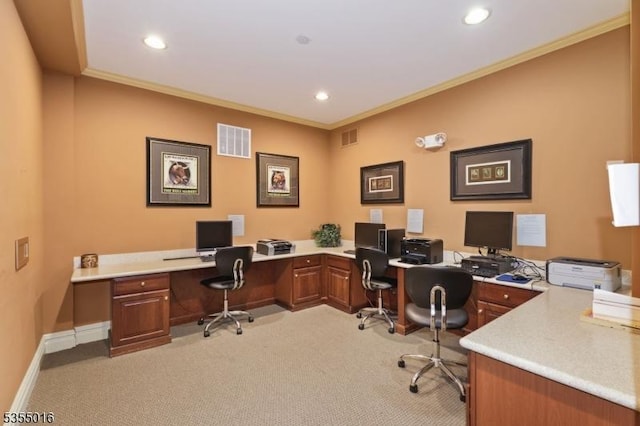 office with light colored carpet, built in desk, and visible vents