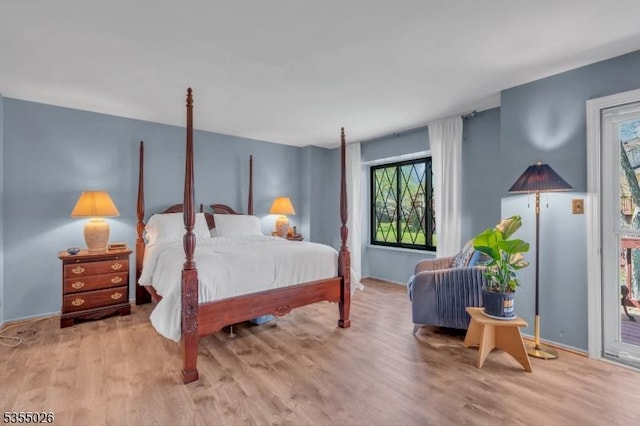 bedroom with baseboards and wood finished floors