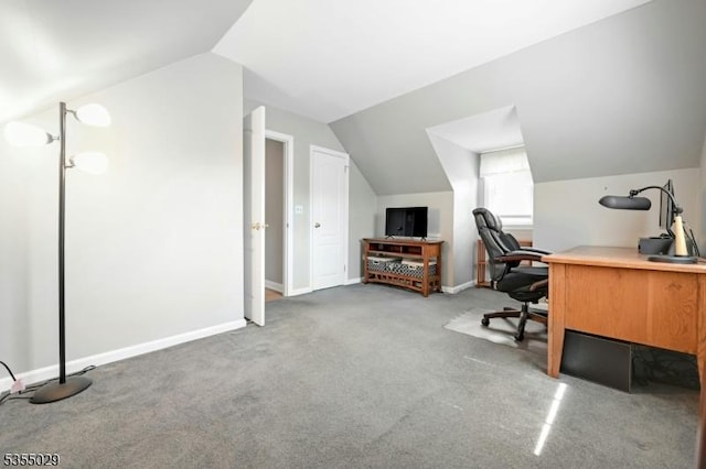 carpeted home office with baseboards and vaulted ceiling