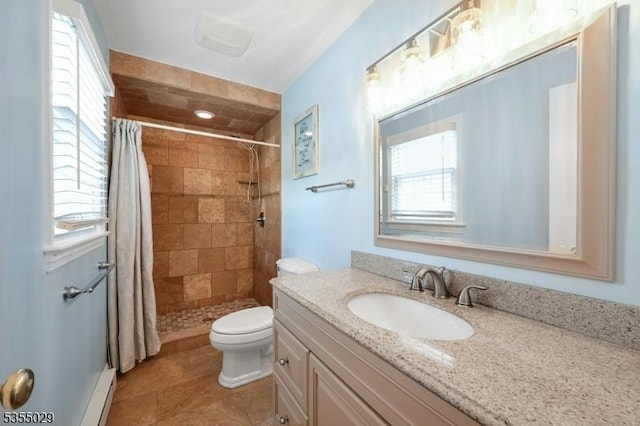 full bath featuring plenty of natural light, tiled shower, and vanity
