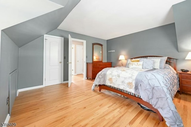 bedroom featuring baseboards and light wood-style flooring