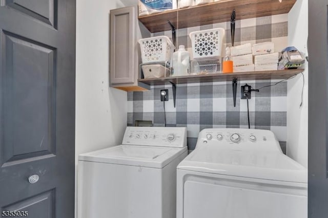 washroom featuring cabinet space and washer and dryer