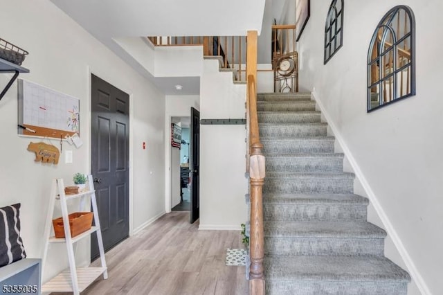stairs featuring baseboards and wood finished floors
