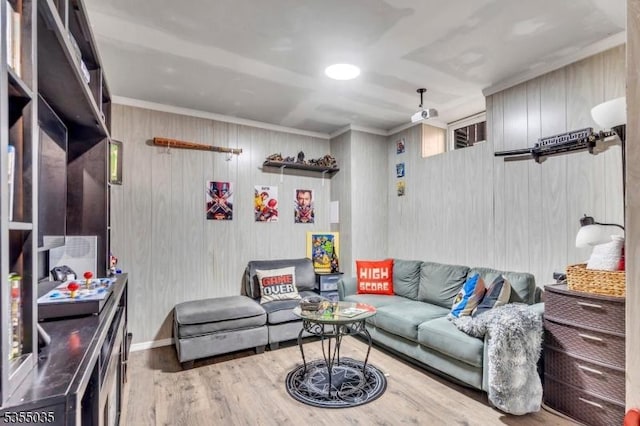 living room with baseboards, crown molding, and wood finished floors