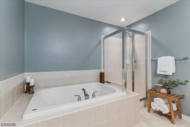 bathroom with tile patterned flooring, a stall shower, and a garden tub