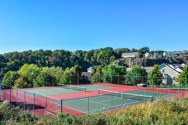 view of sport court featuring fence