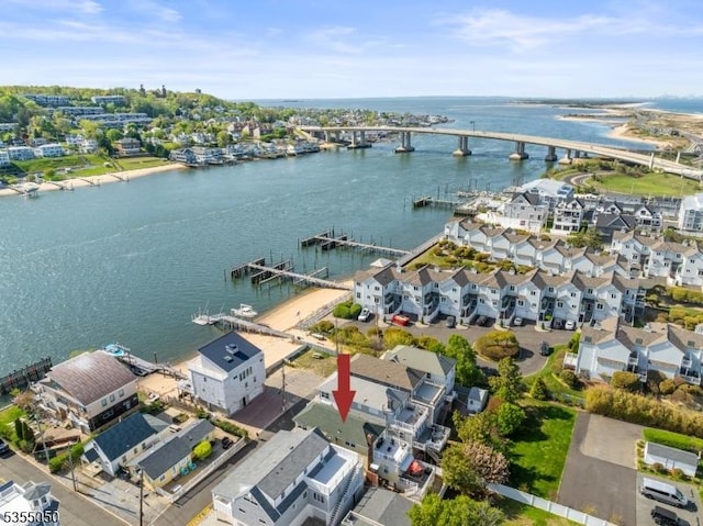 aerial view of residential area with a notable bridge and a nearby body of water