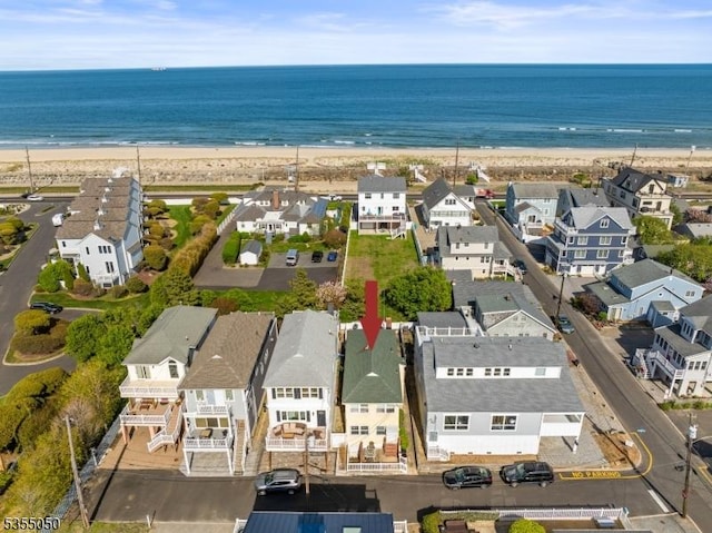 aerial perspective of suburban area featuring waterfront with a beach