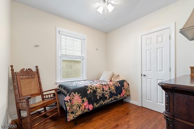 bedroom with wood finished floors and baseboards