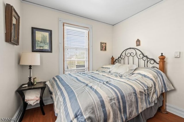 bedroom featuring wood finished floors and baseboards