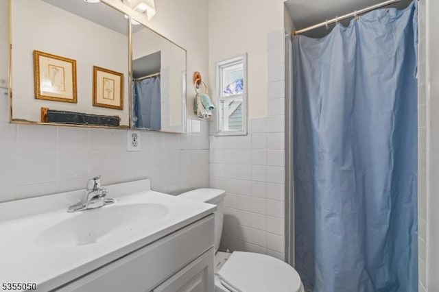 bathroom featuring tile walls, vanity, toilet, and a shower with curtain