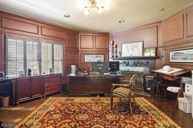 office area with a decorative wall, dark wood-style flooring, a chandelier, and ornamental molding