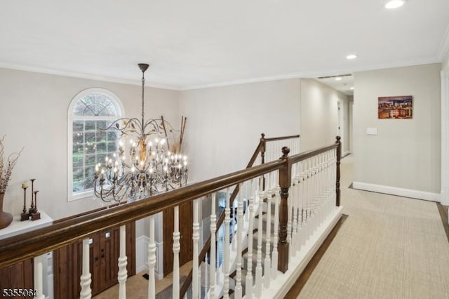 corridor with an upstairs landing, a chandelier, ornamental molding, recessed lighting, and carpet floors