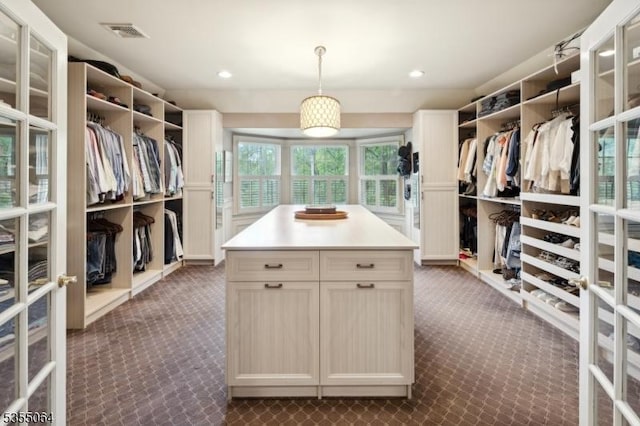 spacious closet featuring dark carpet