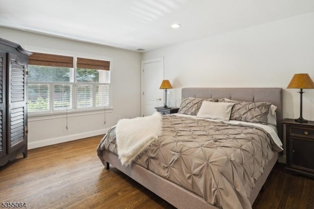 bedroom featuring wood finished floors, baseboards, and recessed lighting