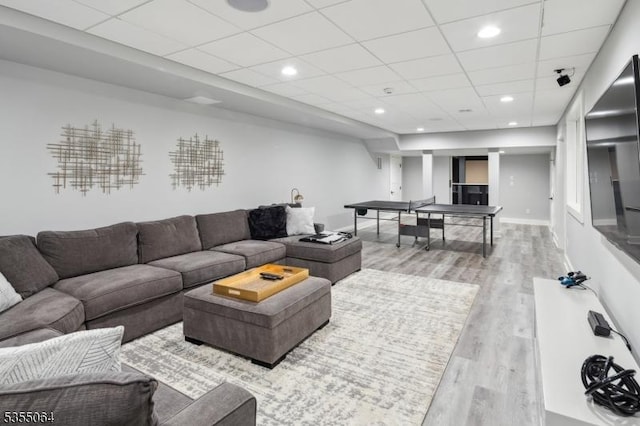 living area featuring wood finished floors, a drop ceiling, and recessed lighting