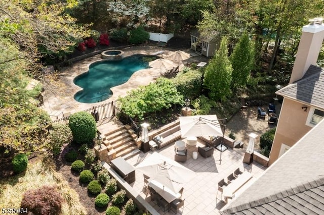 view of swimming pool with a patio and fence