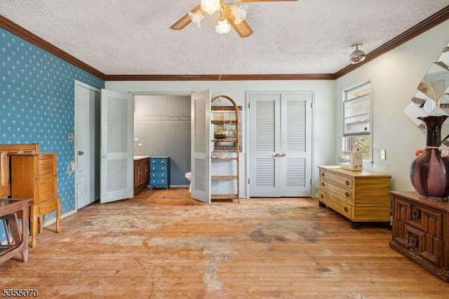 2 Woods End Rd, Parsippany-Troy Hills Twp, NJ 07950 - bedroom with crown molding, multiple closets, wallpapered walls, light wood-type flooring, and a textured ceiling