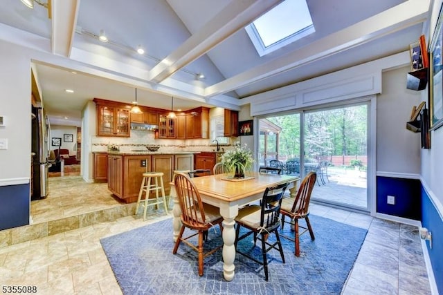 dining area featuring baseboards, recessed lighting, and lofted ceiling with skylight