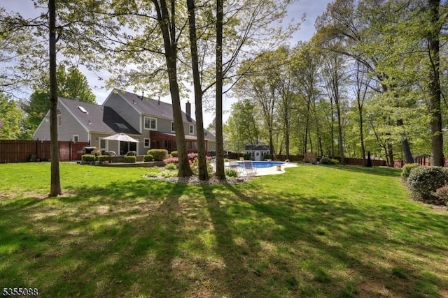 view of yard featuring a fenced in pool and fence