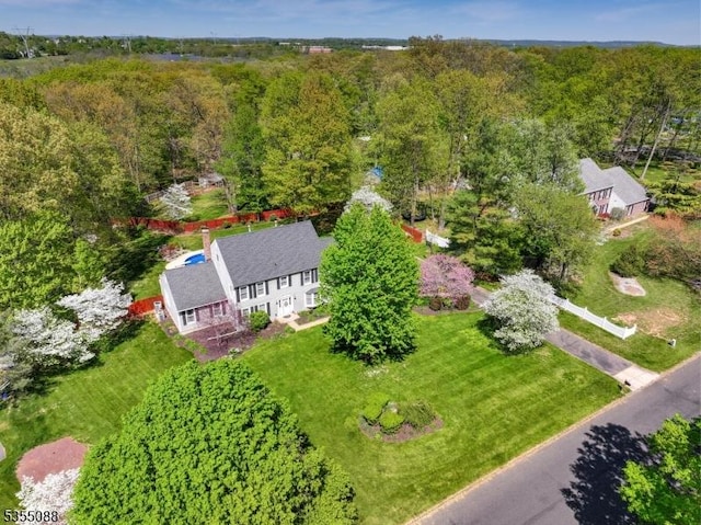 birds eye view of property with a forest view