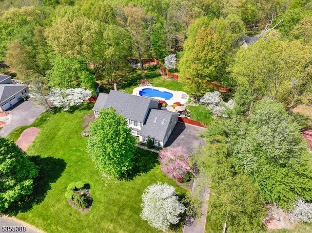 birds eye view of property featuring a wooded view