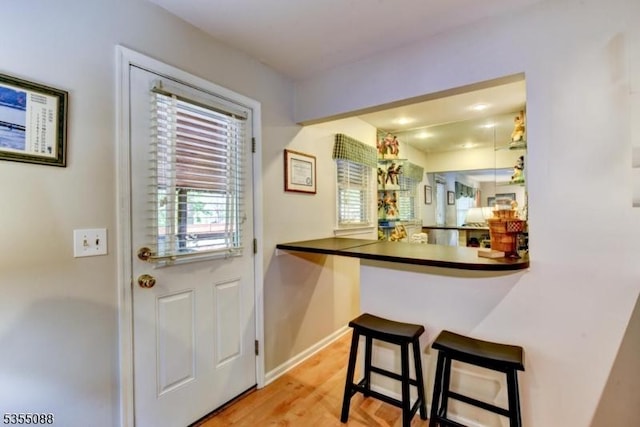 entryway with baseboards and light wood-type flooring