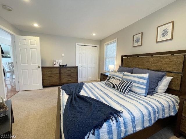 bedroom featuring recessed lighting, light colored carpet, and a closet
