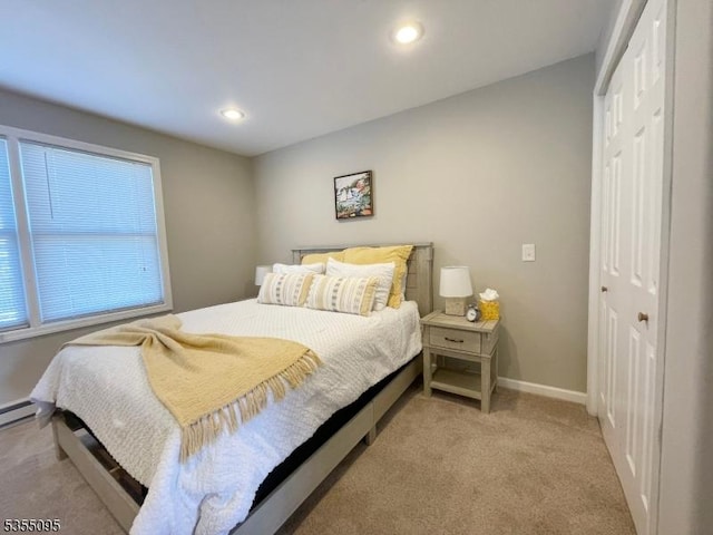 bedroom featuring recessed lighting, baseboards, light colored carpet, and a closet