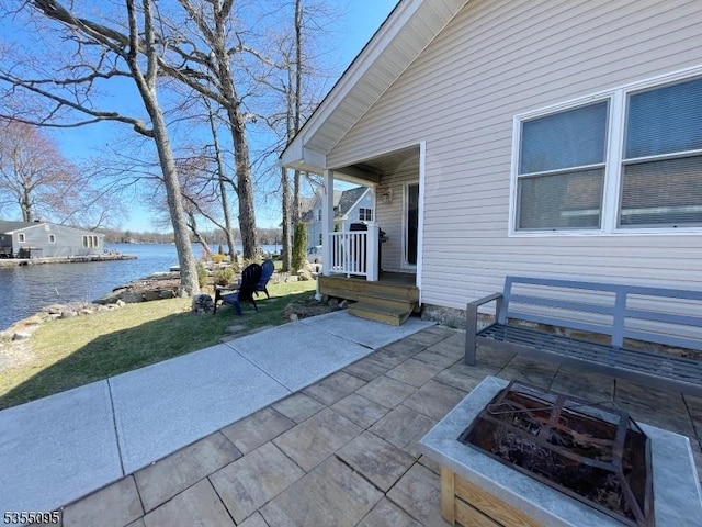 view of patio featuring a water view and an outdoor fire pit