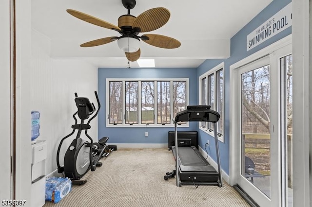 exercise area with baseboards, carpet, and a ceiling fan