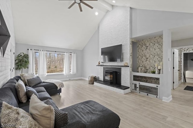 living room featuring wood finished floors, baseboards, high vaulted ceiling, recessed lighting, and a ceiling fan