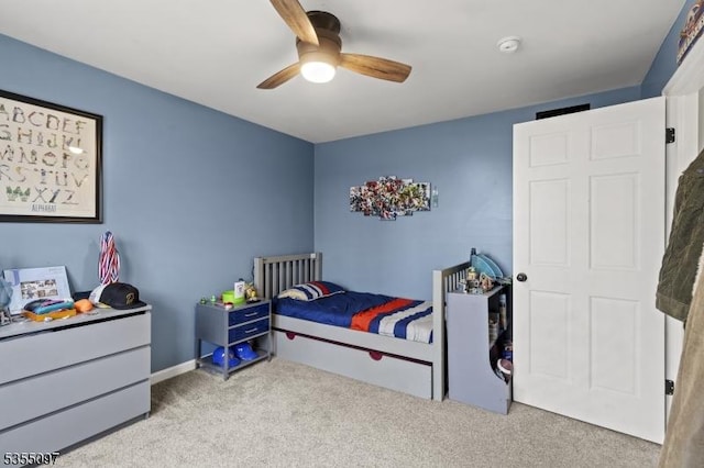 carpeted bedroom with a ceiling fan
