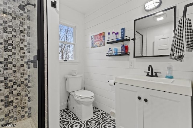 full bath with vanity, tile patterned flooring, toilet, and a shower stall